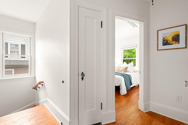 301 Pond St, Boston, MA 02130 - hall with light wood-type flooring, baseboards, and an upstairs landing