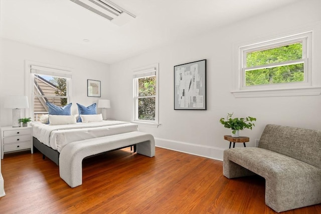 301 Pond St, Boston, MA 02130 - bedroom featuring multiple windows, wood finished floors, and baseboards