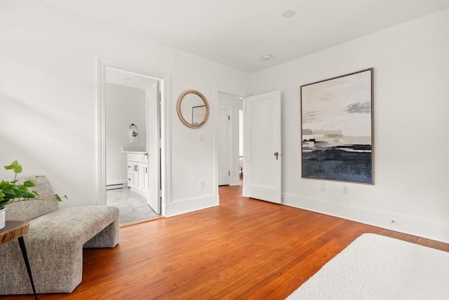301 Pond St, Boston, MA 02130 - bedroom with light wood-type flooring, baseboards, and ensuite bathroom