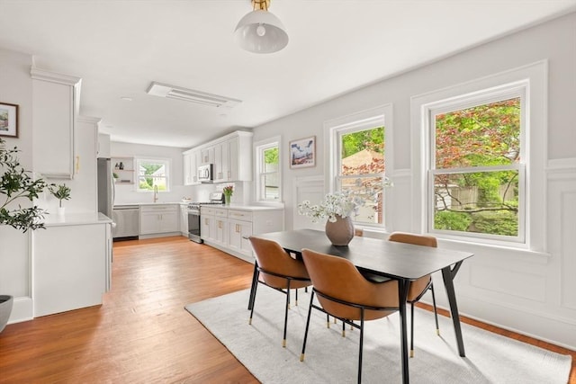 301 Pond St, Boston, MA 02130 - dining room featuring light wood-style flooring and a decorative wall