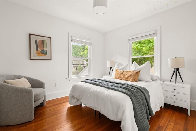 301 Pond St, Boston, MA 02130 - bedroom with multiple windows, baseboards, and wood finished floors