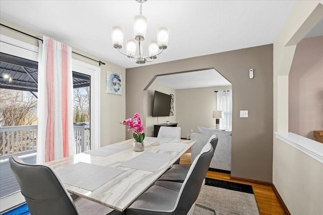 dining room with a notable chandelier and light hardwood / wood-style flooring