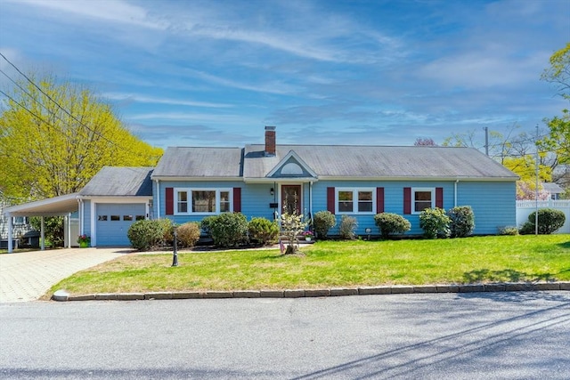 ranch-style house with driveway, a chimney, a front yard, a garage, and an attached carport