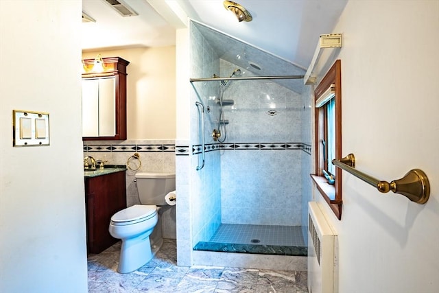 bathroom with visible vents, vanity, toilet, and tiled shower