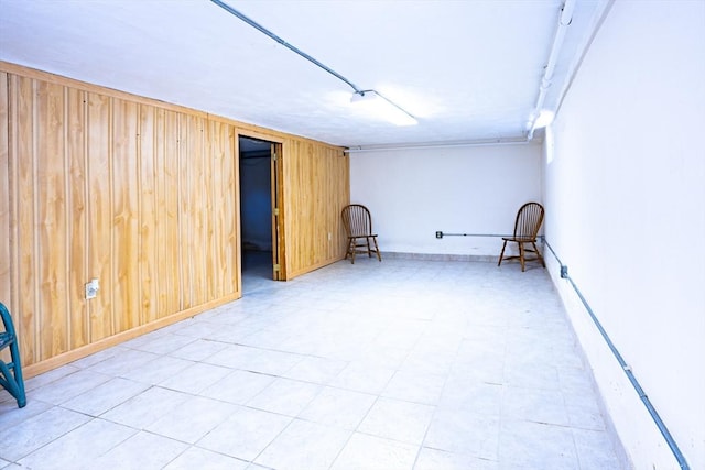 spare room featuring wood walls