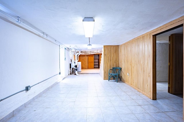 interior space with baseboards and wood walls