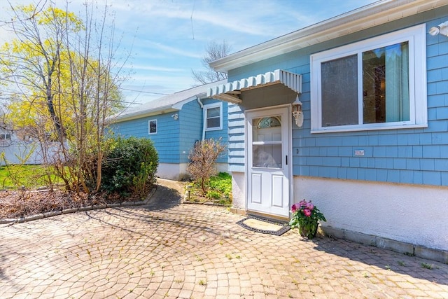 entrance to property featuring a patio