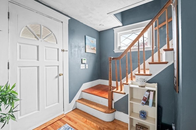 stairs featuring baseboards and hardwood / wood-style flooring