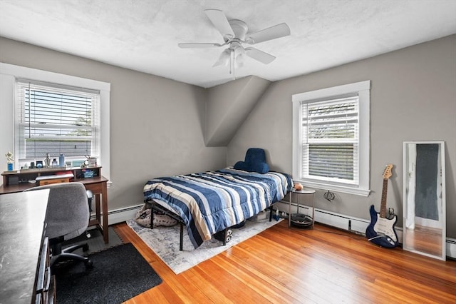 bedroom with baseboards, wood finished floors, and a ceiling fan