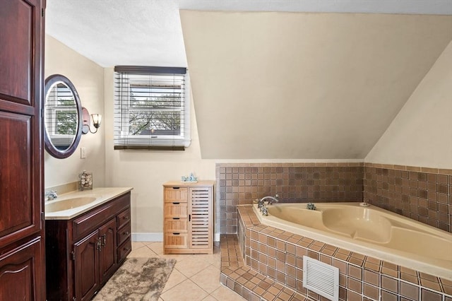 bathroom with vanity, visible vents, vaulted ceiling, tile patterned flooring, and a bath