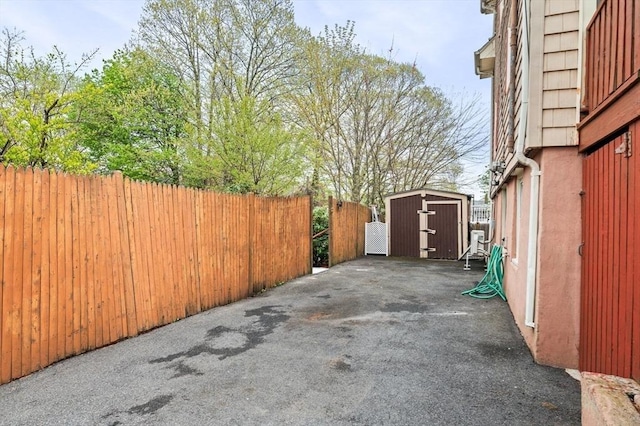 exterior space featuring fence, a shed, and an outdoor structure
