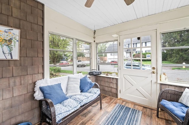 sunroom featuring ceiling fan and a wealth of natural light