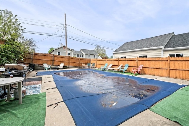 view of swimming pool featuring a patio, a fenced in pool, and a fenced backyard