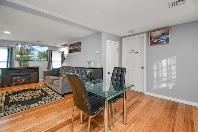 dining space with hardwood / wood-style flooring