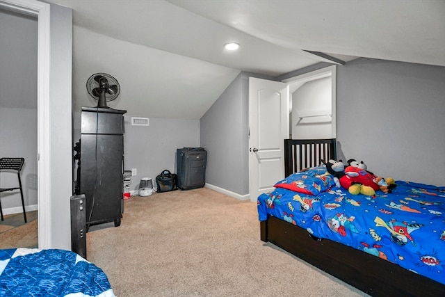 carpeted bedroom with lofted ceiling