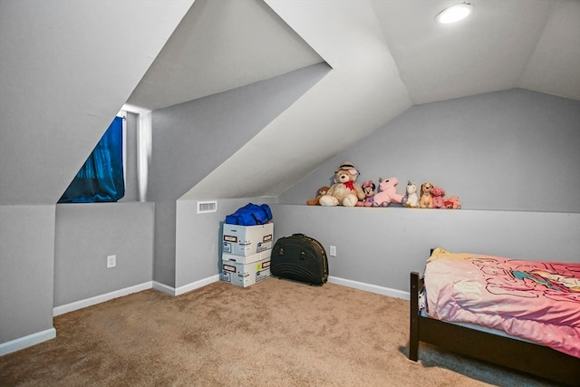 carpeted bedroom with vaulted ceiling