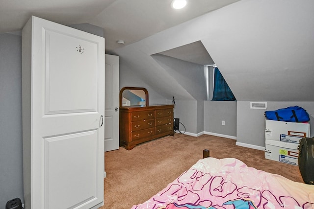 bedroom featuring lofted ceiling and light carpet