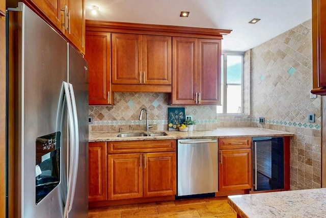 33 Pond Ave Unit Ph1207, Brookline, MA 02445 - kitchen with appliances with stainless steel finishes, wine cooler, a sink, light wood finished floors, and light stone counters