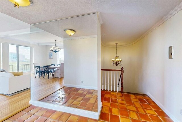 33 Pond Ave Unit Ph1207, Brookline, MA 02445 - entrance foyer with a chandelier, baseboards, ornamental molding, a textured ceiling, and wood finished floors
