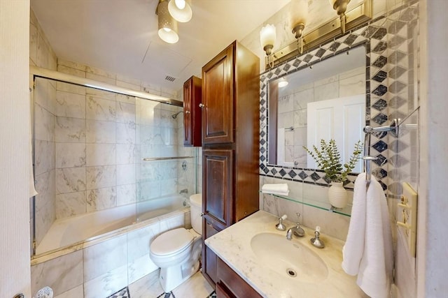 33 Pond Ave Unit Ph1207, Brookline, MA 02445 - bathroom featuring tiled shower / bath combo, tile walls, vanity, and toilet
