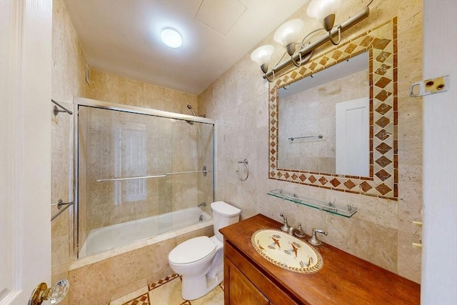 33 Pond Ave Unit Ph1207, Brookline, MA 02445 - full bath with tile walls, toilet, tiled shower / bath, vanity, and tile patterned floors