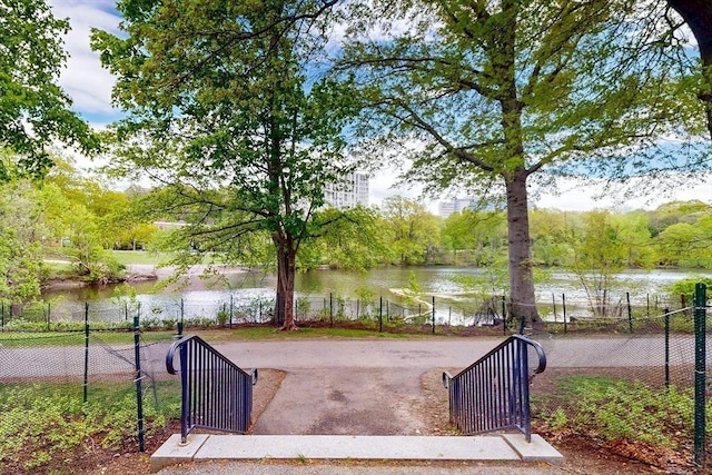 33 Pond Ave Unit Ph1207, Brookline, MA 02445 - view of home's community with a water view, fence, and a gate