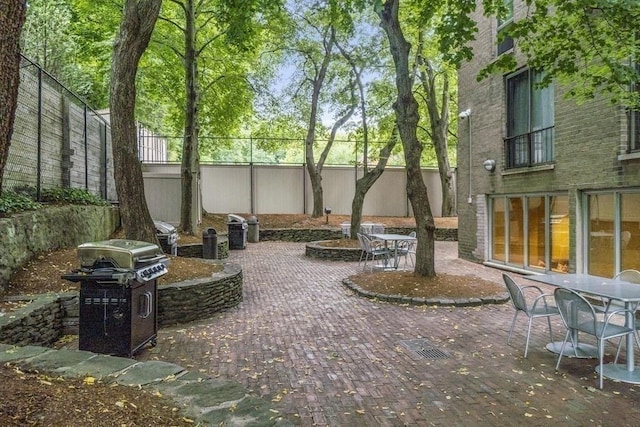 33 Pond Ave Unit Ph1207, Brookline, MA 02445 - view of patio / terrace featuring a grill, outdoor dining area, and a fenced backyard