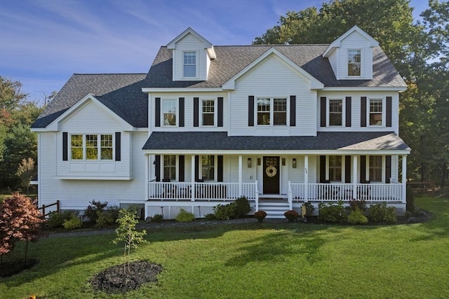 view of front of home featuring covered porch, a shingled roof, and a front yard