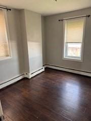 620 Dudley St, Boston, MA 02125 - spare room with wood finished floors and baseboard heating