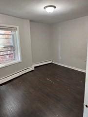 620 Dudley St, Boston, MA 02125 - empty room with wood finished floors and baseboards