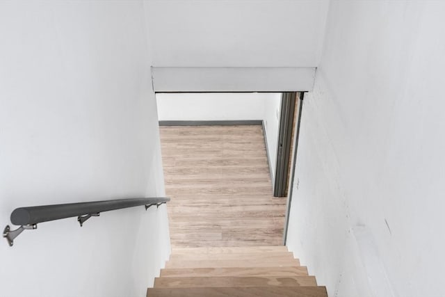 stairway featuring hardwood / wood-style floors