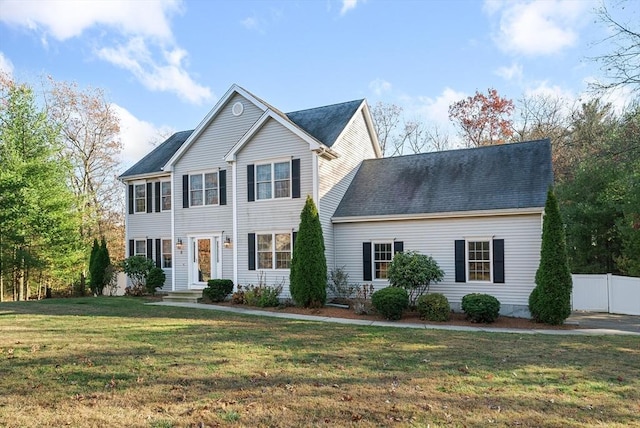 view of front of home with fence and a front yard