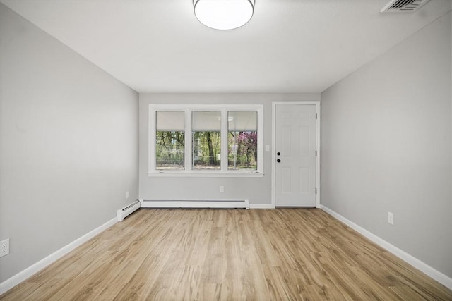 73 Mckinley Ave, Ludlow, MA 01056 - spare room featuring visible vents, a baseboard heating unit, baseboards, and wood finished floors