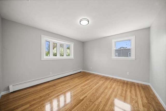 73 Mckinley Ave, Ludlow, MA 01056 - spare room featuring baseboards, a baseboard heating unit, plenty of natural light, and wood finished floors