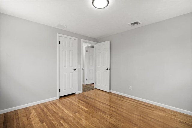 73 Mckinley Ave, Ludlow, MA 01056 - unfurnished bedroom featuring baseboards, wood finished floors, visible vents, and a closet