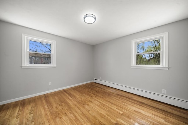 73 Mckinley Ave, Ludlow, MA 01056 - empty room with baseboards, a baseboard heating unit, and light wood-style flooring