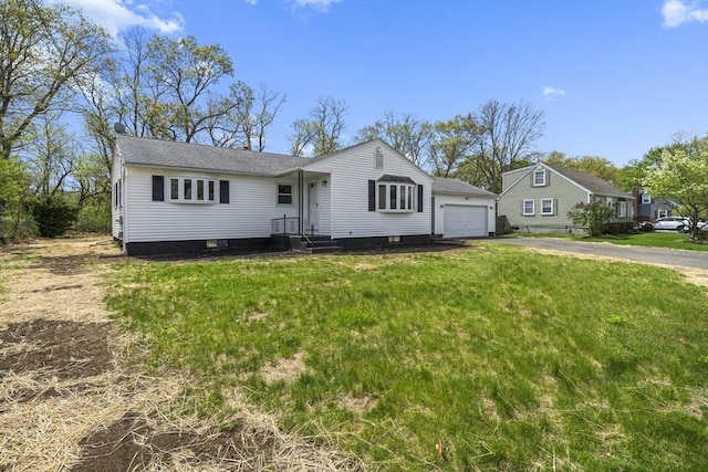 73 Mckinley Ave, Ludlow, MA 01056 - view of front of property featuring an attached garage, a front lawn, and aphalt driveway
