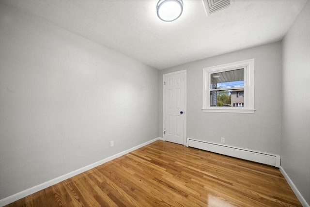 73 Mckinley Ave, Ludlow, MA 01056 - empty room with baseboards, a baseboard radiator, wood finished floors, and visible vents
