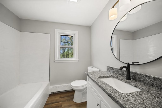 73 Mckinley Ave, Ludlow, MA 01056 - full bathroom featuring vanity, toilet, wood finished floors, and a baseboard radiator