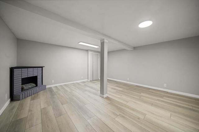 73 Mckinley Ave, Ludlow, MA 01056 - finished below grade area with baseboards, light wood finished floors, and a fireplace