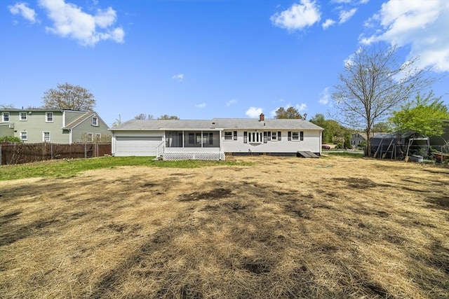 73 Mckinley Ave, Ludlow, MA 01056 - back of house featuring fence, a chimney, and a sunroom