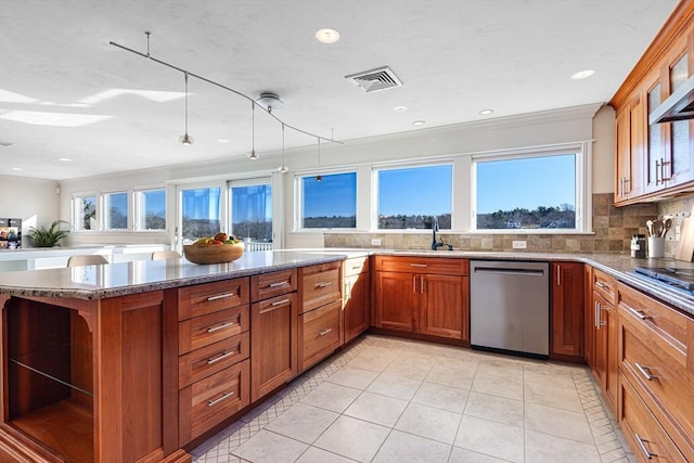 kitchen with stainless steel appliances, tasteful backsplash, sink, and a healthy amount of sunlight