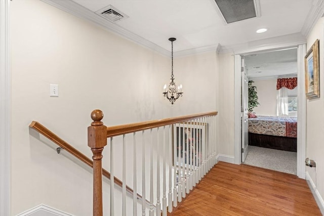 hallway featuring ornamental molding and wood-type flooring