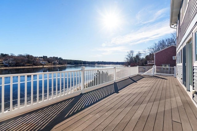 wooden terrace featuring a water view