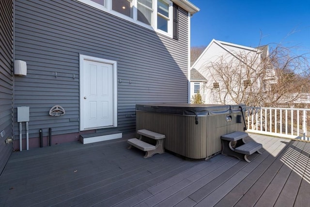 wooden terrace featuring a hot tub