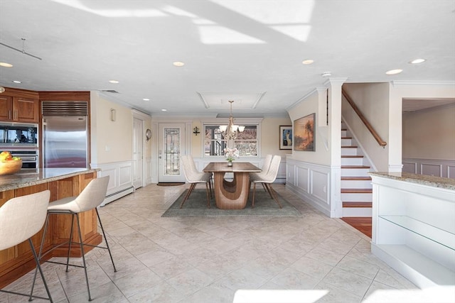 dining room with crown molding and a baseboard heating unit