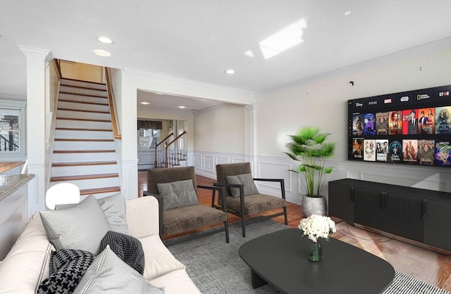 living room featuring crown molding and light hardwood / wood-style flooring