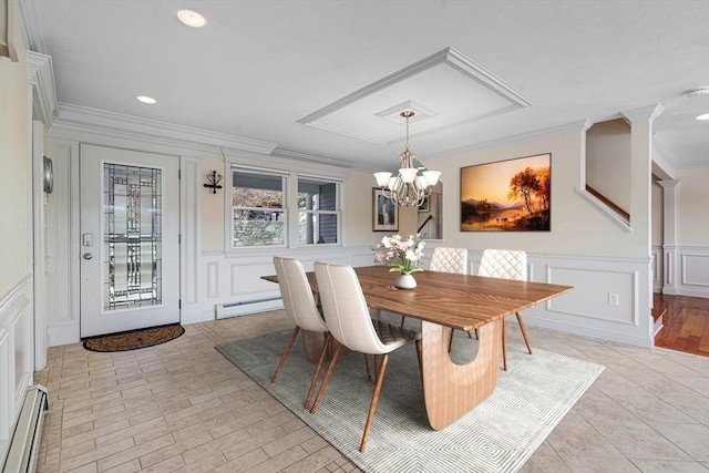 dining room with ornamental molding, a chandelier, and baseboard heating