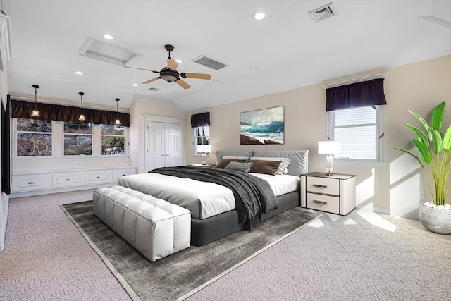 bedroom with dark colored carpet, vaulted ceiling, ceiling fan, and a closet