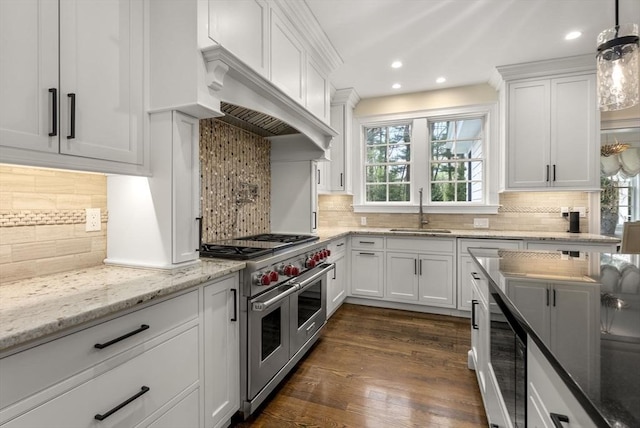 kitchen with white cabinetry, double oven range, sink, and premium range hood